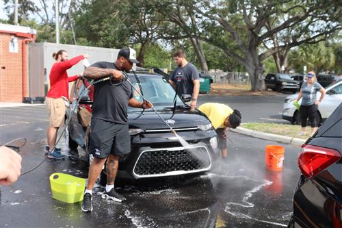 Football players washing cars
